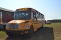 A Yellow School Bus Parked On The Grass Royalty Free Stock Photo