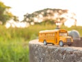 yellow school bus plastic and metal toy model on the country road Royalty Free Stock Photo