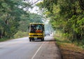 Yellow school bus on the road in Thailand