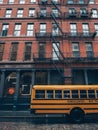 Yellow school bus at a skyscraper