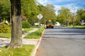 Yellow School Bus Standing On The Side Of A Wide Street In A Residential Neighborhood With Nobody Around