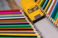 Yellow school bus toy with colored pencils Royalty Free Stock Photo