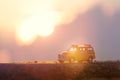 Yellow school bus toy model crossing through the country road Royalty Free Stock Photo