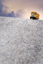 Yellow school bus toy model on the road. Royalty Free Stock Photo