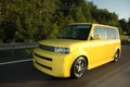 Yellow Scion xB driving on the Highway Royalty Free Stock Photo