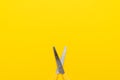 Yellow scissors on the yellow background with copy space