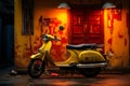 a yellow scooter parked in front of a building Royalty Free Stock Photo