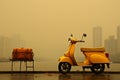 a yellow scooter parked next to a bench Royalty Free Stock Photo