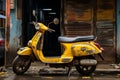 a yellow scooter parked on the side of the road Royalty Free Stock Photo