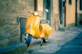 Yellow scooter in tuscan Cortona town Royalty Free Stock Photo