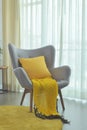 Yellow scraft and yellow pillow setting on gray color easy armch