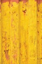 Yellow sea freight container background, rusty corrugated pattern, red primer coating, vertical rusted detailed steel texture