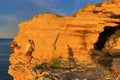 Yellow seaside cliffs explore man Royalty Free Stock Photo
