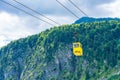 Yellow Seilbahn cable car gondola against Zwolferhorn mountain Royalty Free Stock Photo