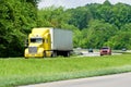 Yellow Semi Truck Leading Traffic On Highway