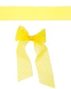 Yellow semitransparent dotted ribbon with a bow