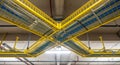 Yellow server room cable trays with blue and gray wires. Data center infrastructure for big data management and network cabling Royalty Free Stock Photo
