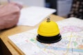 Yellow service bell on reception. Hotel service bell and the map of Krakow, written in Polish language