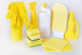 Yellow set of products for washing and cleaning. Rubber gloves, chemical bottles, sponges and rags. Royalty Free Stock Photo