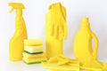 Yellow set of products for washing and cleaning. Rubber gloves, chemical bottles, sponges and rags. Royalty Free Stock Photo