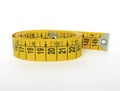 Yellow sewing tape measure isolated on white background. Front view of body measurement ruler, with centimeters and inches Royalty Free Stock Photo