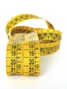 Yellow sewing tape measure isolated on white background. Front view of body measurement ruler, with centimeters and inches Royalty Free Stock Photo