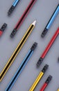 Yellow sharp pencil tip in group of many pencil eraser heads on gray background in vertical frame for background design, concept Royalty Free Stock Photo