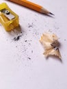 Yellow sharpener. Orange pencil. Pencil scraper Royalty Free Stock Photo