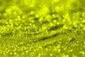 Yellow shining aluminium sand made of glitters - bright concept with bokeh texture - cute abstract photo background