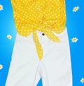 Yellow shirt with knot and white jeans