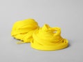 Yellow shoe laces on light grey background Royalty Free Stock Photo