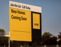 Yellow Sign Advertising New Homes being built in a suburb Royalty Free Stock Photo