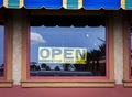 Yellow sign with black letters in the window at restaurant stating they are Open For Take Out Royalty Free Stock Photo