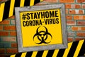 Sign in front of a clinker wall with stay home and corona virus Royalty Free Stock Photo