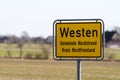 Yellow sign in front of the village WESTEN near Husum