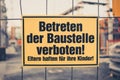 Yellow sign in german: Betreten der Baustelle verboten! Eltern h