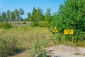 Yellow sign marking buried radioactive material in Chernobyl exclusion zone in the Ukraine Royalty Free Stock Photo