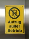Yellow sign with the note Elevator Out of service Detail with German Word Aufzug au er Betrieb