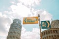 Yellow sign pointer and arrow directing to tickets in the streets of Pisa, Italy