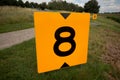 Yellow sign at rowing facility in Zeven huizen with the number 8