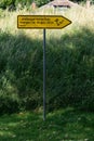 Yellow sign with text: state garden show, pointing to a grassy area.