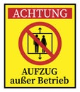 Yellow sign with warning symbol and German text for ELEVATOR OUT OF SERVICE