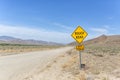 Yellow sign warns of rough country road going across the nevada desert Royalty Free Stock Photo