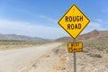 Yellow sign warns of rough country road going across the nevada desert Royalty Free Stock Photo
