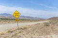 Yellow sign warns of rough country road going across the nevada desert Royalty Free Stock Photo