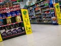 Yellow signage in a branch of UK supermarket ASDA reminds customers to stay safe