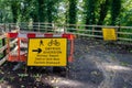 Yellow signs placed outdoors in English and Welsh saying 'Footpath ahead closed"