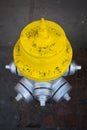 Yellow and silver fire hydrant on the street Royalty Free Stock Photo