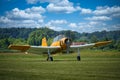 Yellow single-engine propeller plane on a grassy field Royalty Free Stock Photo