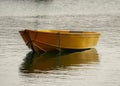 Yellow single fishing boat in the pond, close-up